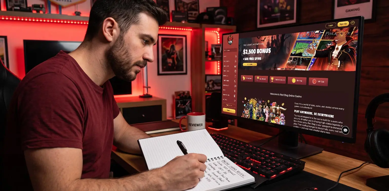 Man taking notes while reviewing an online casino